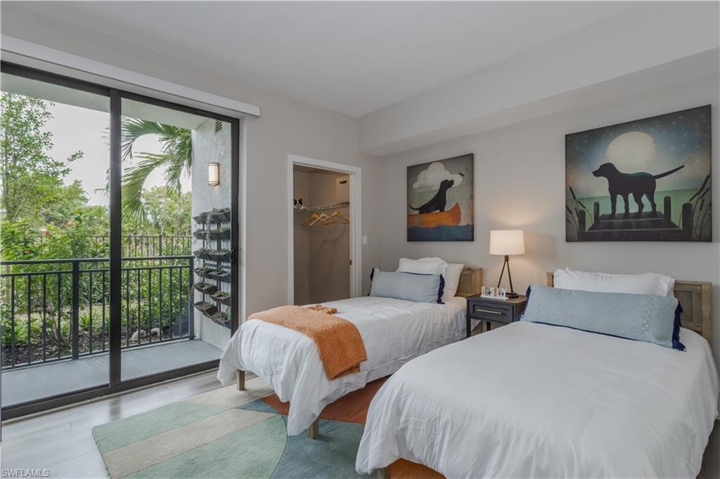 Bedroom featuring access to outside and a walk in closet