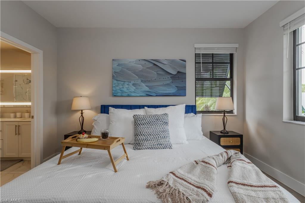 Bedroom with baseboards and ensuite bathroom