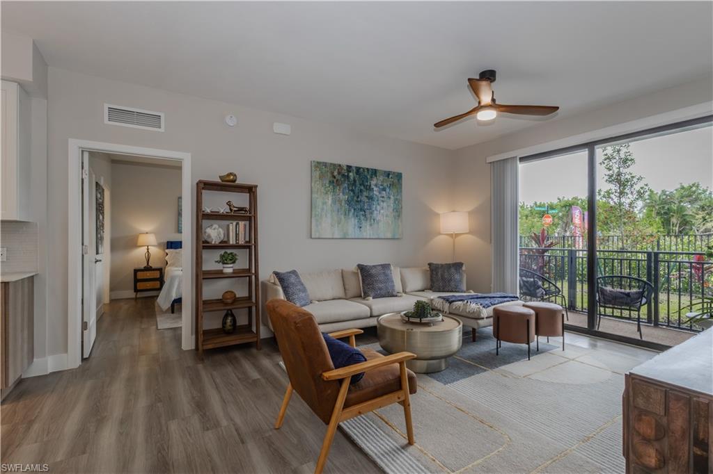 Living area featuring light wood-style floors and a ceiling fan