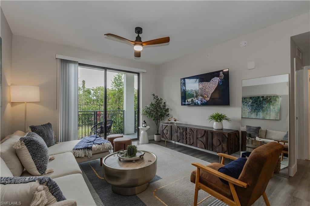 Living room with a ceiling fan and wood finished floors