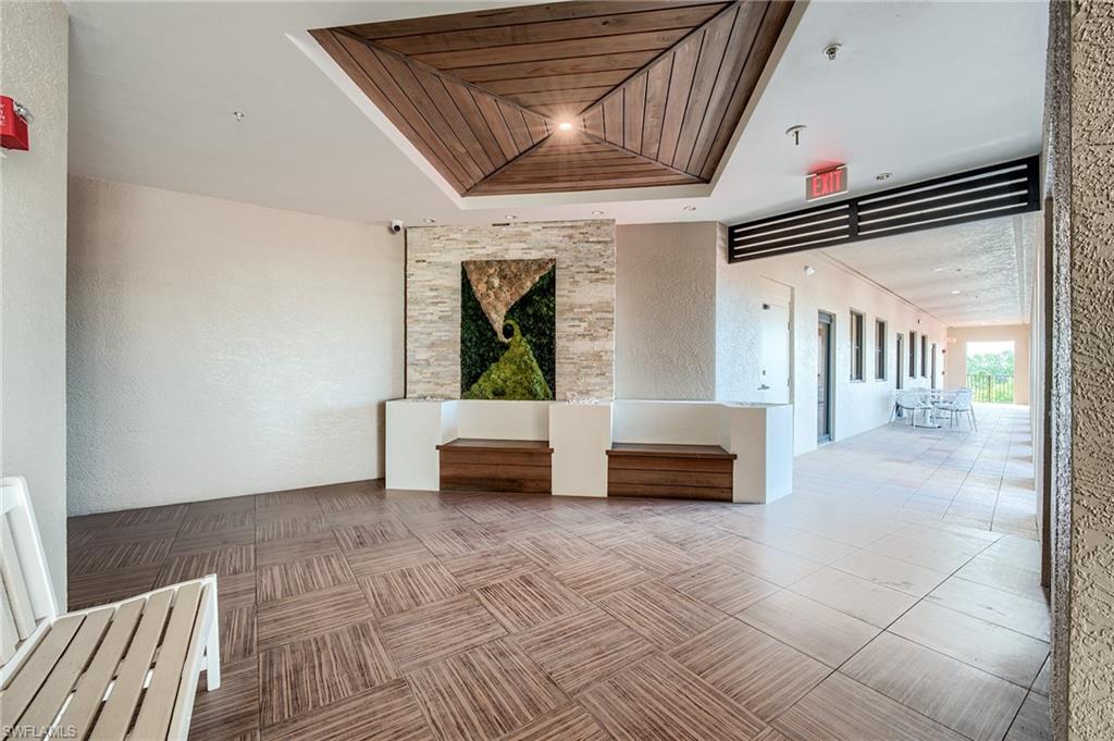 Common area with a textured wall and wood ceiling