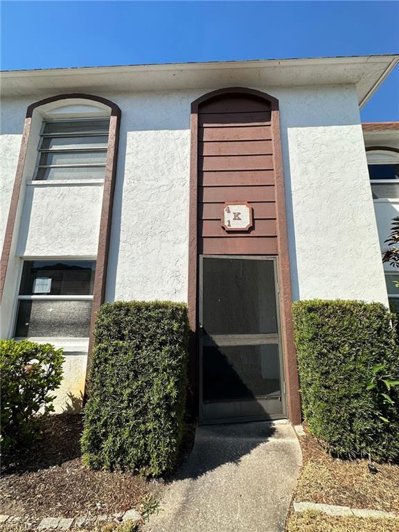 Entrance to property featuring stucco siding