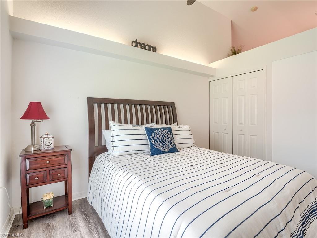 Bedroom featuring wood finished floors and a closet