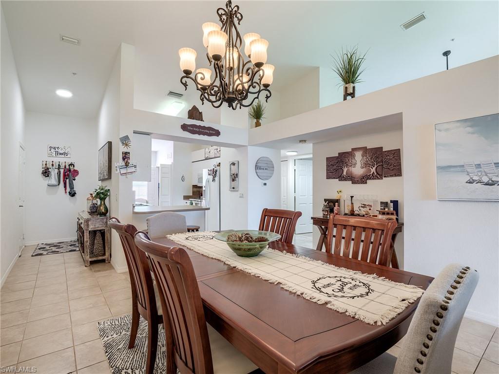 Dining area with light tile patterned flooring and baseboards