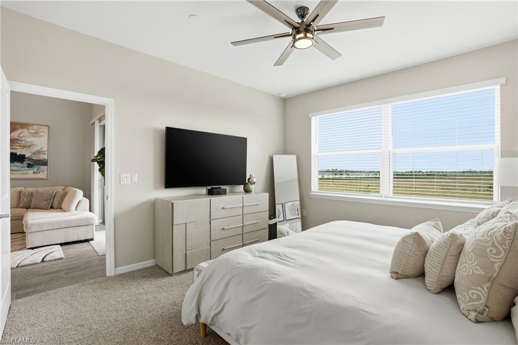 Bedroom with ceiling fan and carpet floors