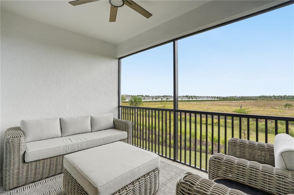 Sunroom featuring a ceiling fan, an outdoor hangout area, and a balcony