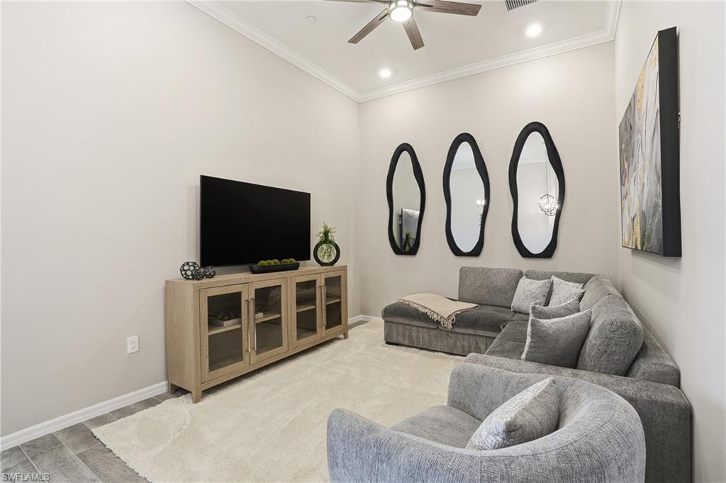 Living room with crown molding, ceiling fan, and recessed lighting