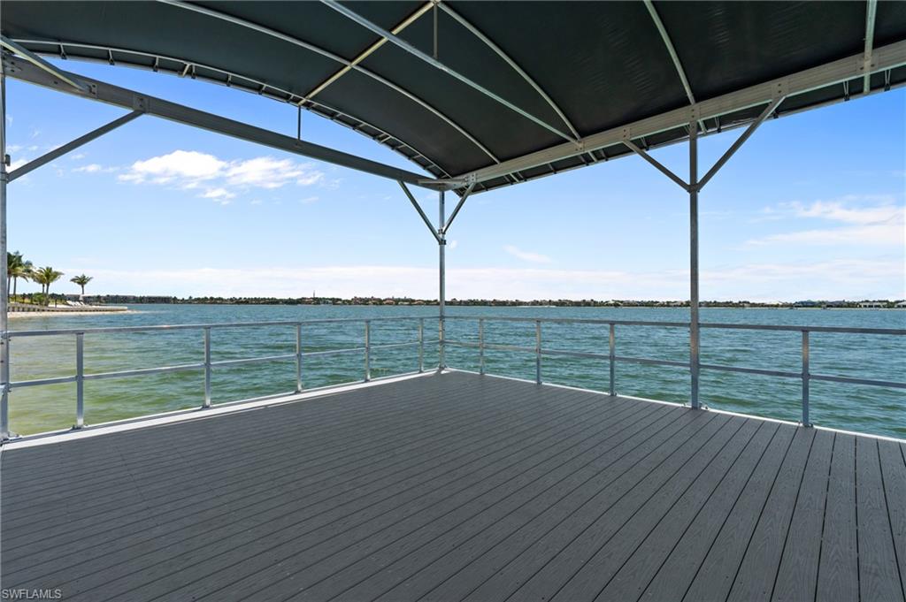 Dock area featuring a deck with water view
