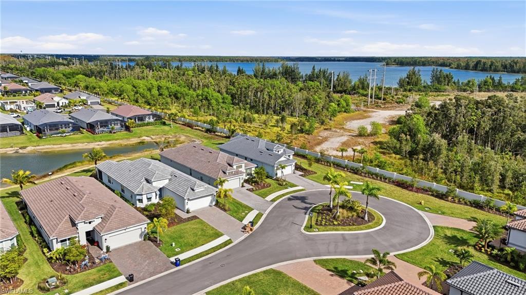 Aerial perspective of suburban area featuring a large body of water