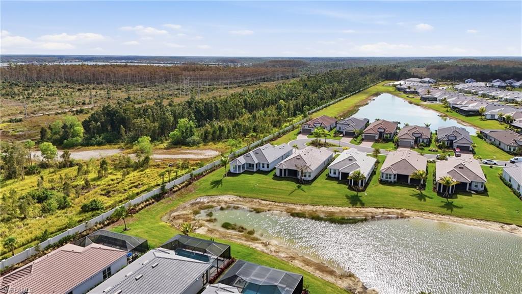 Aerial view of residential area featuring a nearby body of water