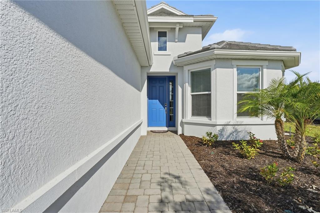 View of exterior entry featuring stucco siding