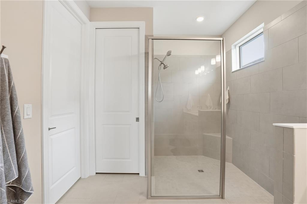 Full bathroom featuring walk in shower, light tile patterned flooring, and recessed lighting