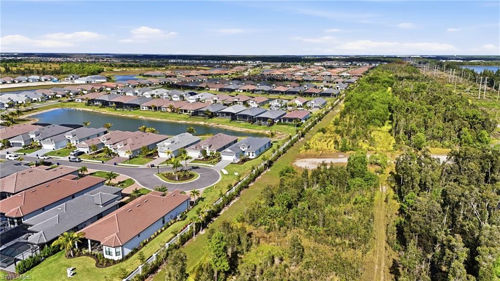 Aerial view of property's location featuring a large body of water and nearby suburban area