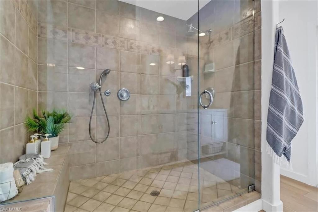 Bathroom with wood-type flooring and an enclosed shower