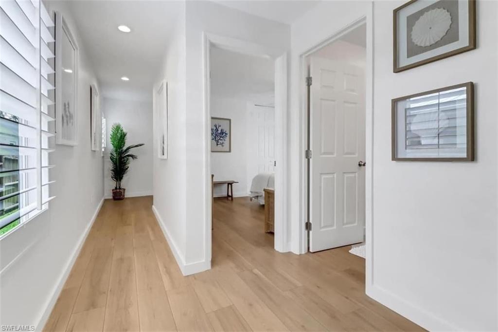 Hall featuring light wood-type flooring