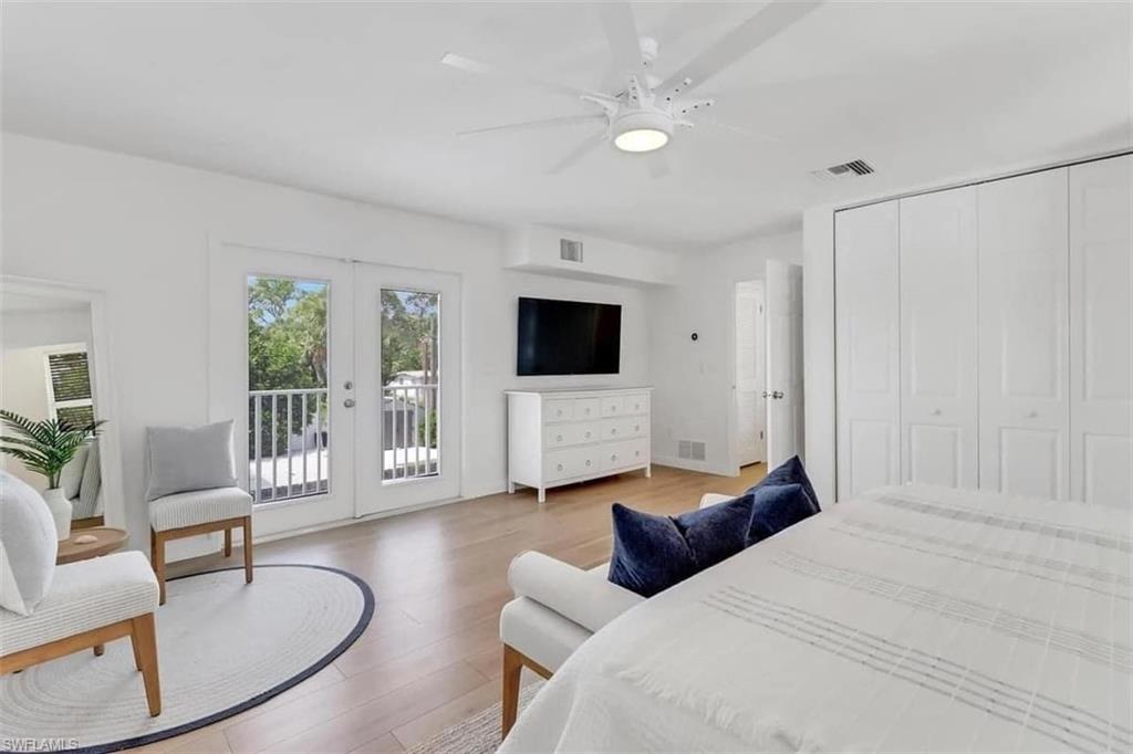 Bedroom featuring access to exterior, french doors, ceiling fan, hardwood / wood-style floors, and a closet