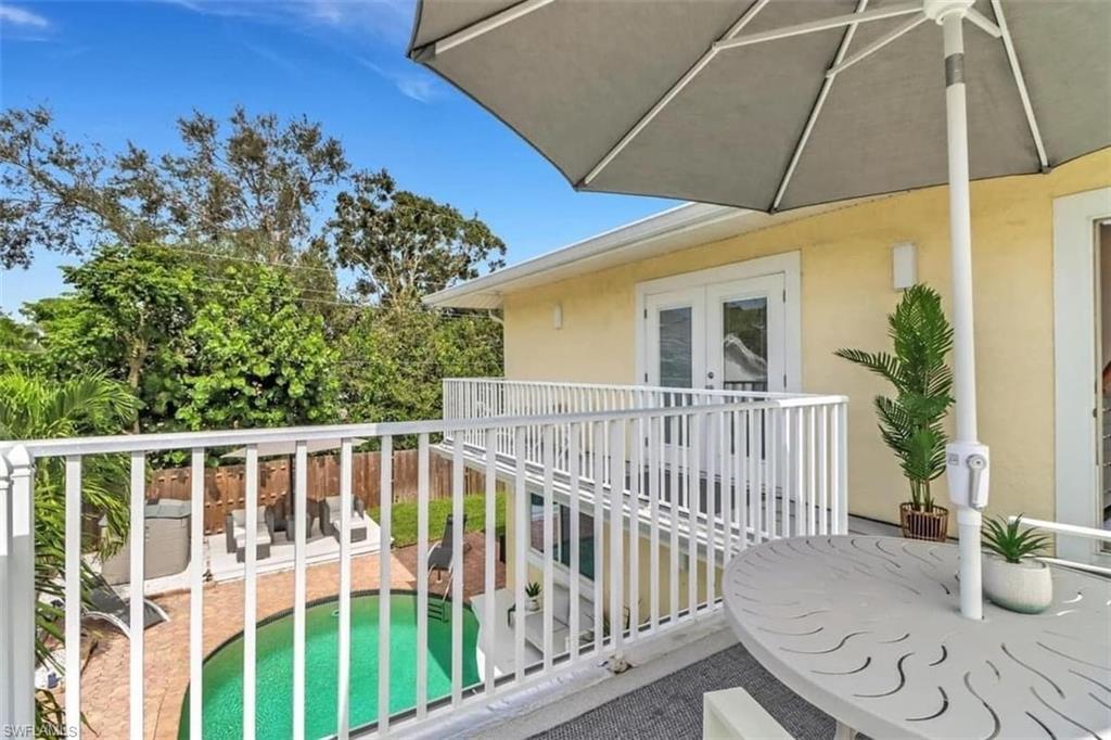 View of swimming pool featuring a patio area and a grill