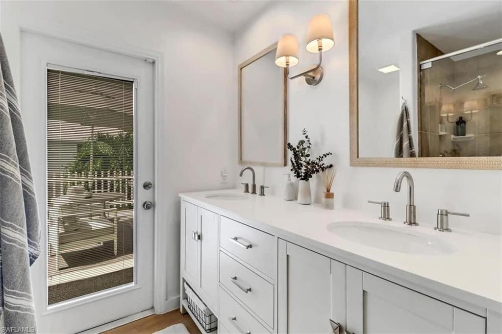 Bathroom with vanity and a shower with door