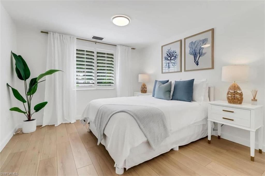 Bedroom with light hardwood / wood-style flooring