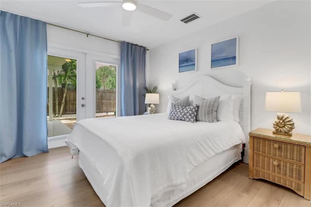 Bedroom with access to exterior, ceiling fan, french doors, and wood-type flooring