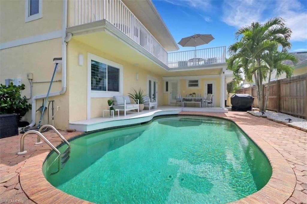 View of swimming pool featuring a patio area and a grill