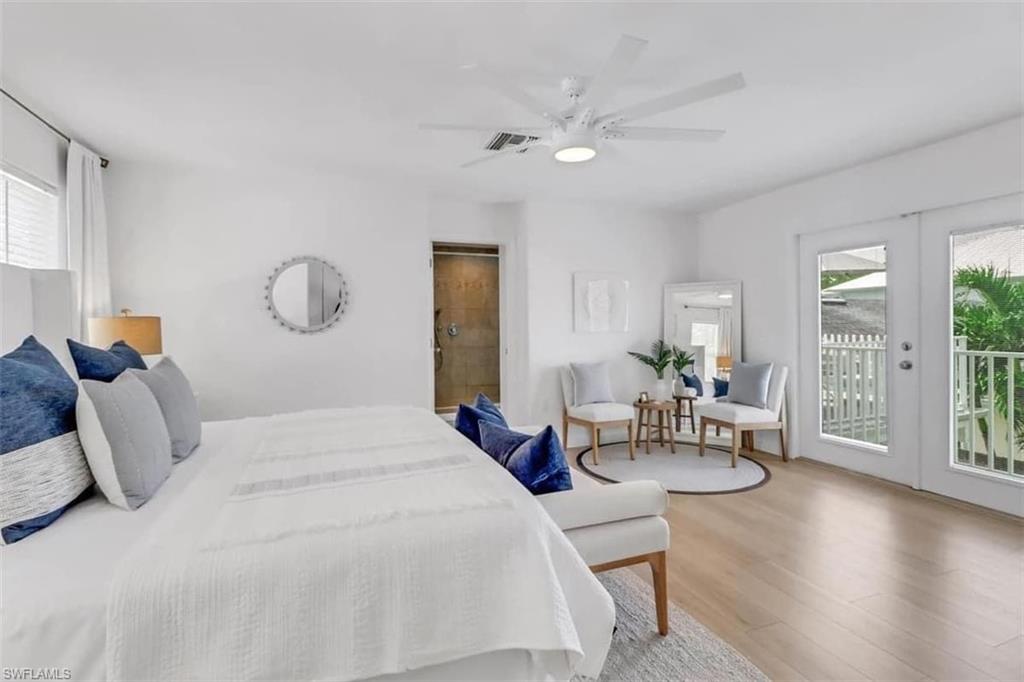 Bedroom featuring ceiling fan, access to exterior, multiple windows, and french doors