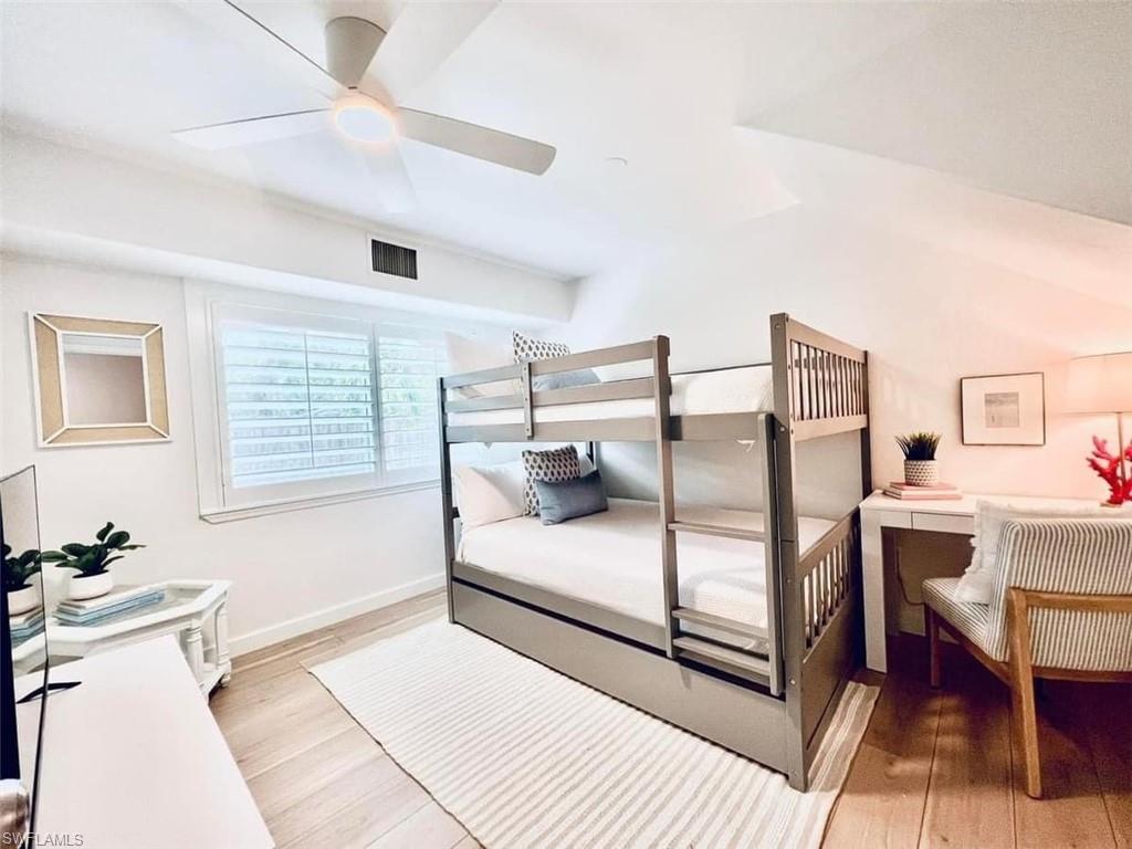 Bedroom with light hardwood / wood-style floors and ceiling fan
