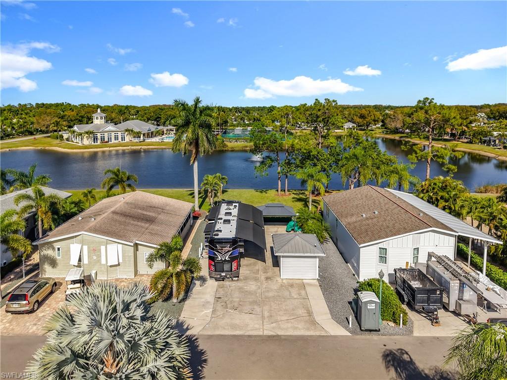 Aerial perspective of suburban area with a tree filled landscape and a large body of water
