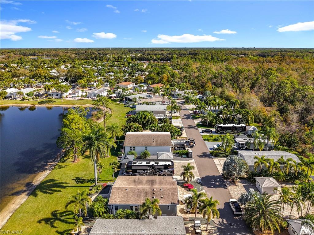 Aerial perspective of suburban area featuring a nearby body of water