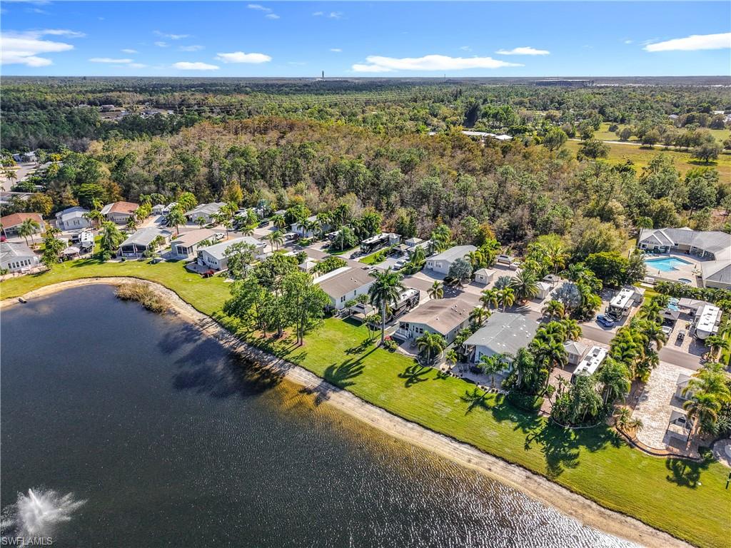Aerial perspective of suburban area featuring a nearby body of water