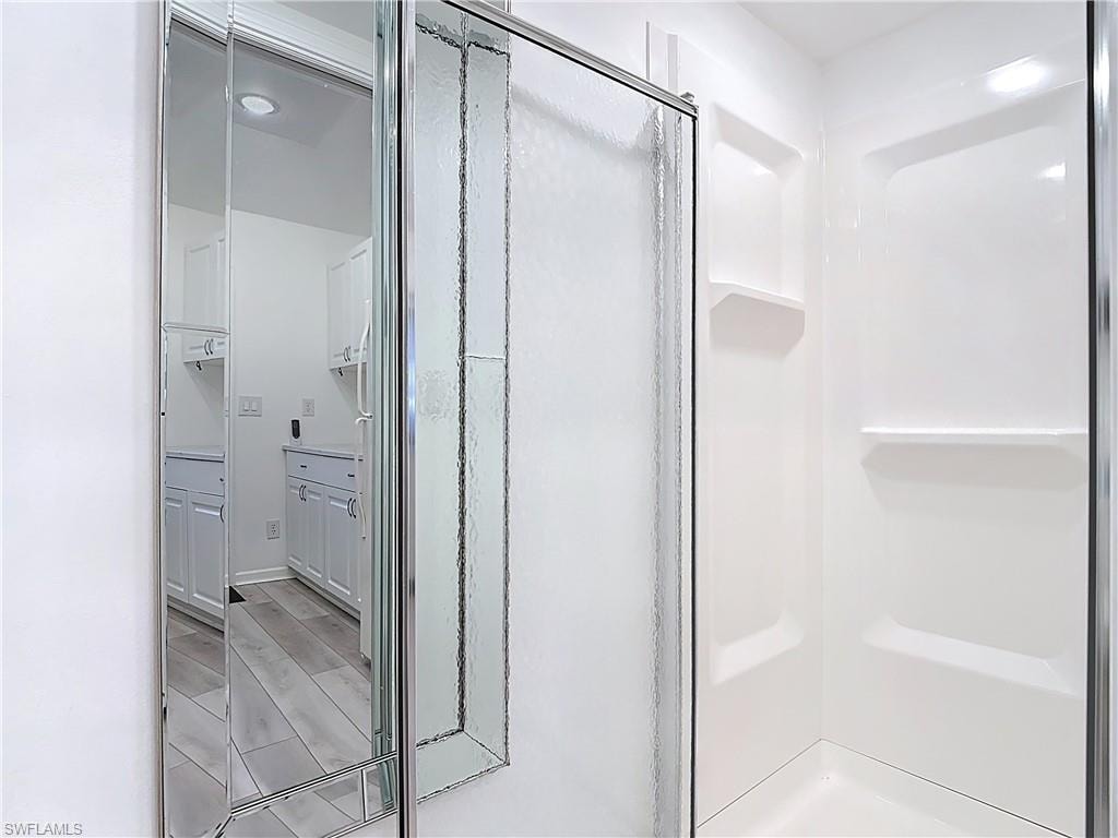 Bathroom featuring a stall shower and wood tiled floors