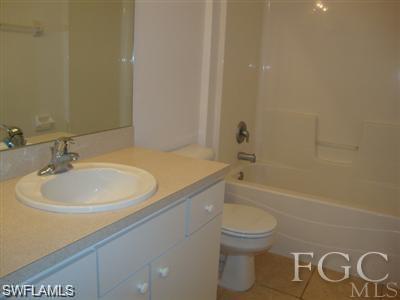 Full bathroom with vanity, bathtub / shower combination, and light tile patterned floors