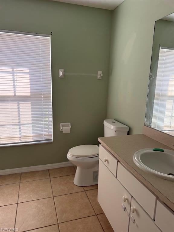 Bathroom featuring light tile patterned flooring and vanity