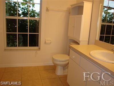 Bathroom with vanity and light tile patterned flooring