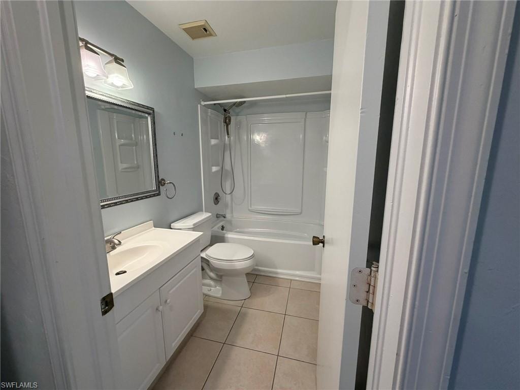 Full bathroom with vanity, light tile patterned flooring, and bathtub / shower combination