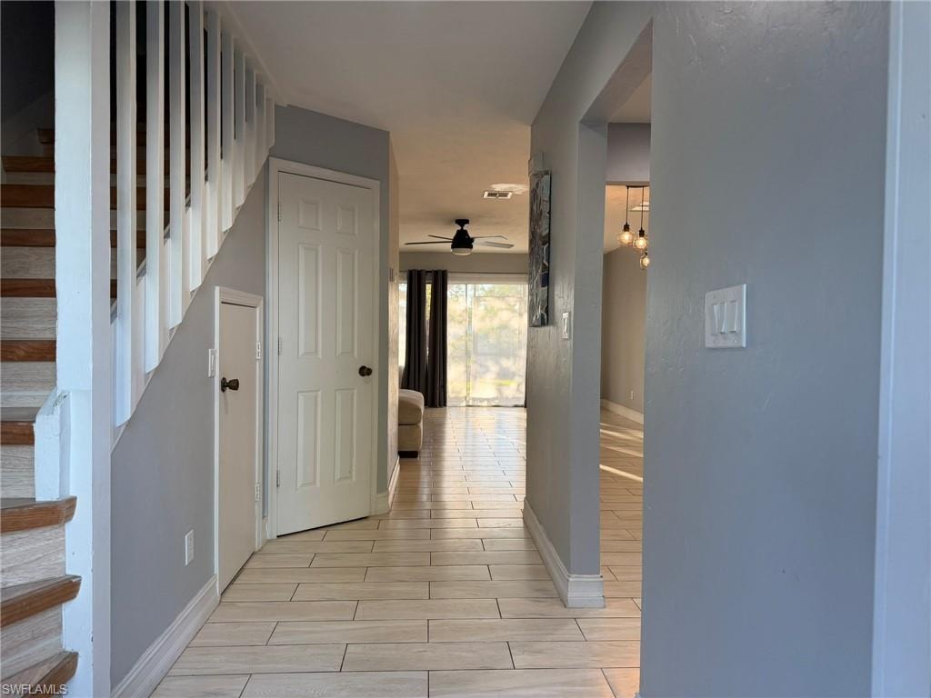 Hall with stairway and wood finish floors