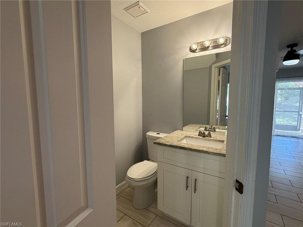 Half bathroom featuring vanity and light tile patterned flooring