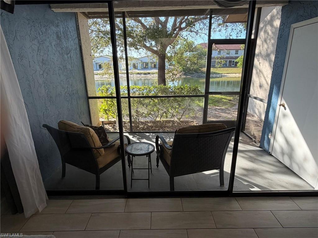 Sunroom / solarium featuring a water view and healthy amount of natural light