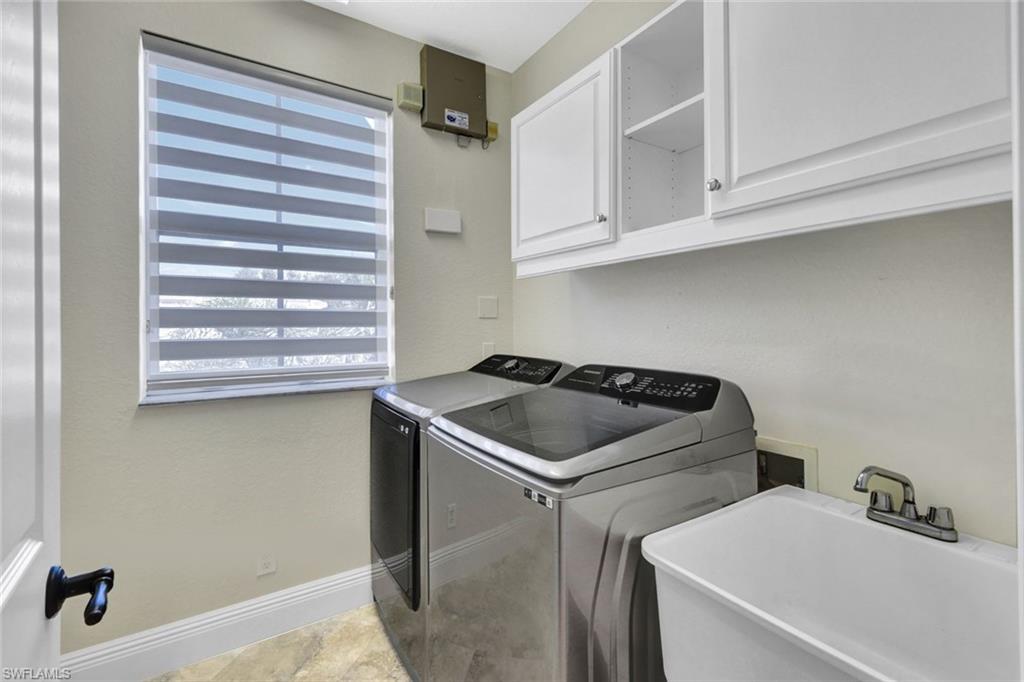 Laundry area featuring cabinet space and washer and dryer