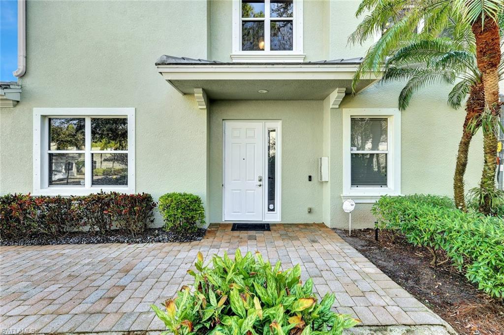 Doorway to property featuring stucco siding