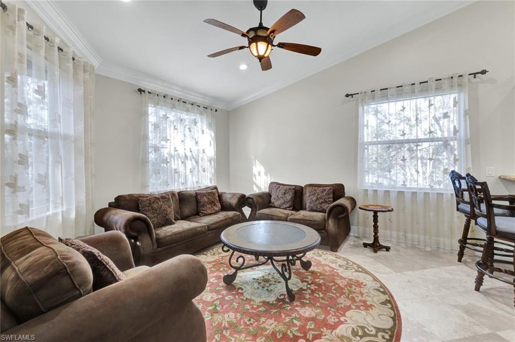 Living area featuring crown molding, healthy amount of natural light, recessed lighting, and ceiling fan