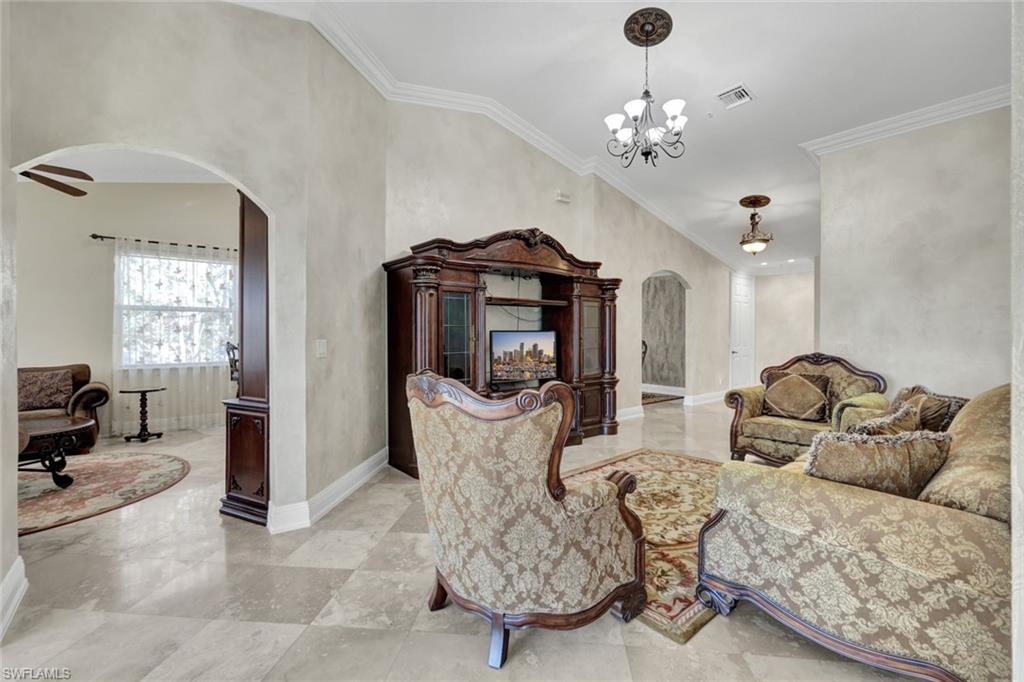 Living area with arched walkways and crown molding