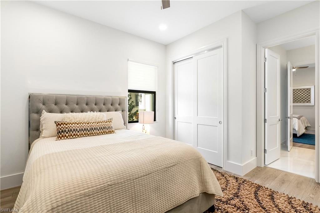 Bedroom featuring wood finished floors, a closet, a ceiling fan, and recessed lighting