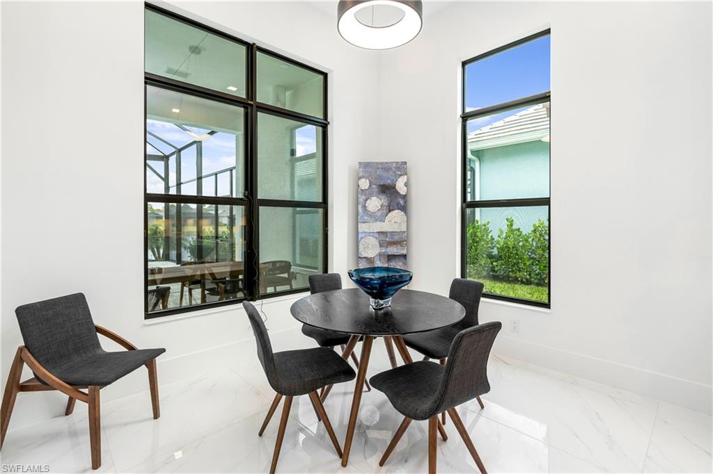 Dining space featuring marble finish flooring