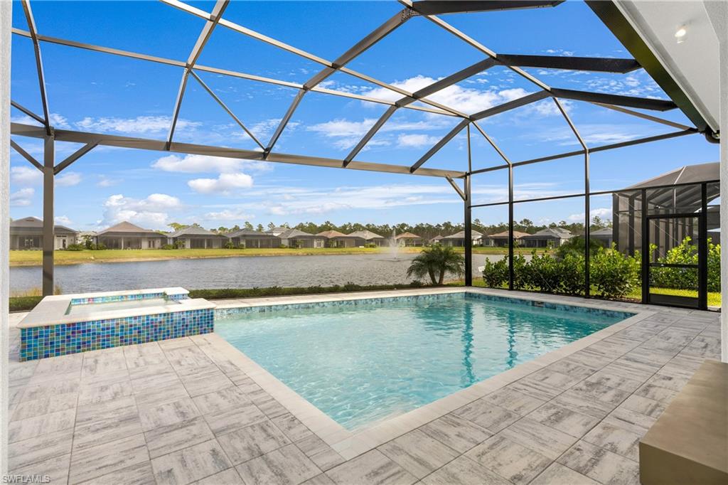 View of swimming pool with a sunroom, glass enclosure, a residential view, a patio, and a water view