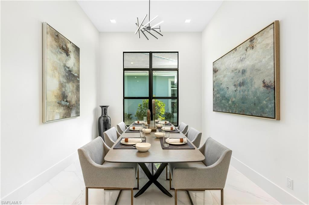 Dining room featuring a chandelier and marble look tiles