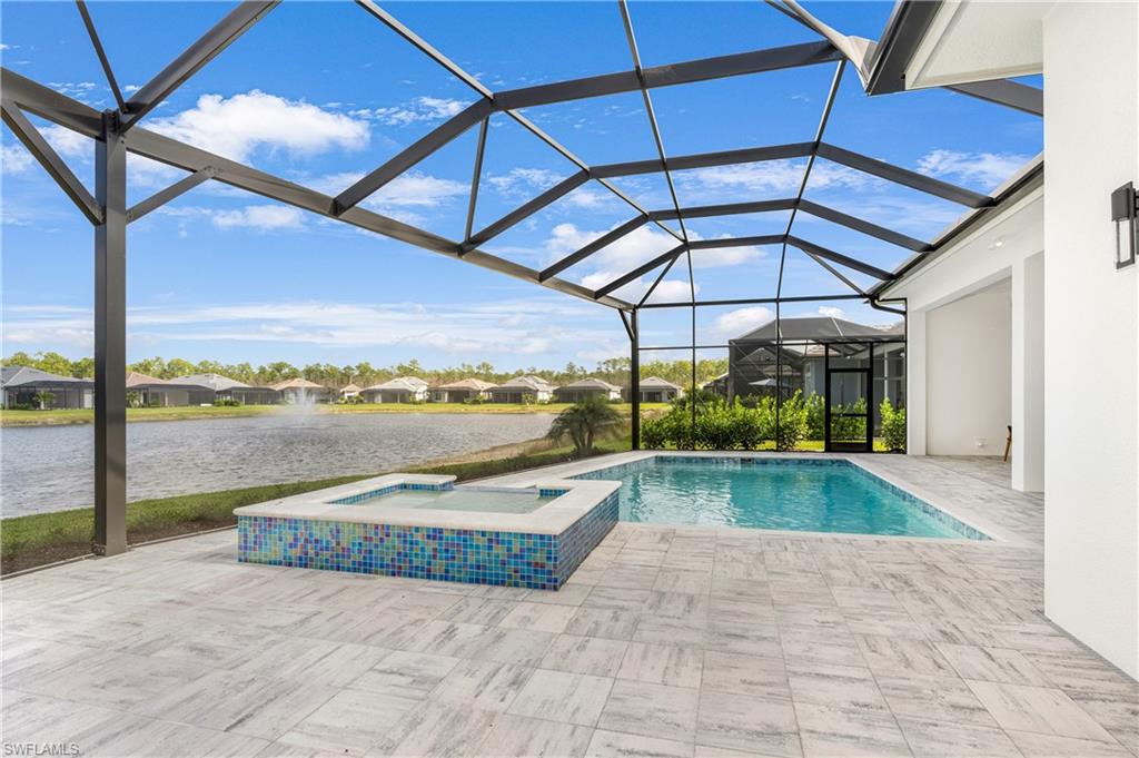 View of swimming pool with a sunroom, a water view, a residential view, a patio area, and a pool with connected hot tub