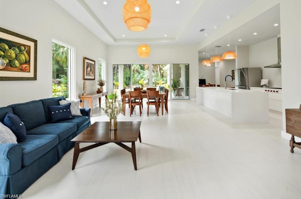 Living area with a tray ceiling and recessed lighting