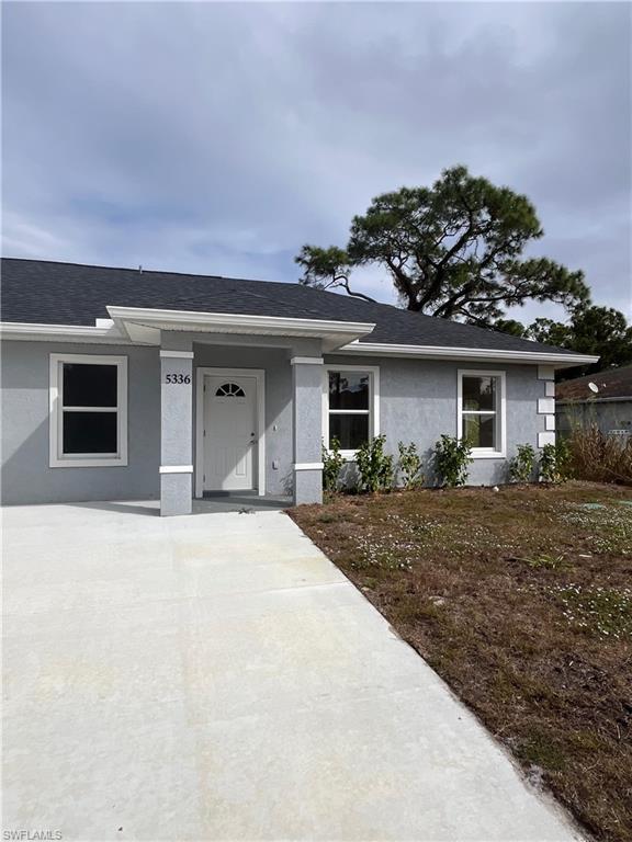 Ranch-style home with stucco siding and roof with shingles