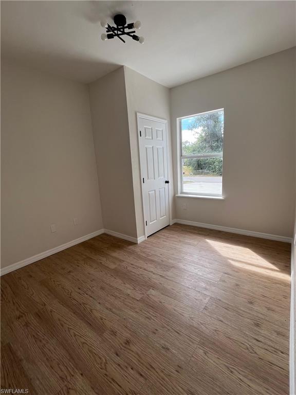 Unfurnished bedroom featuring baseboards and light wood finished floors